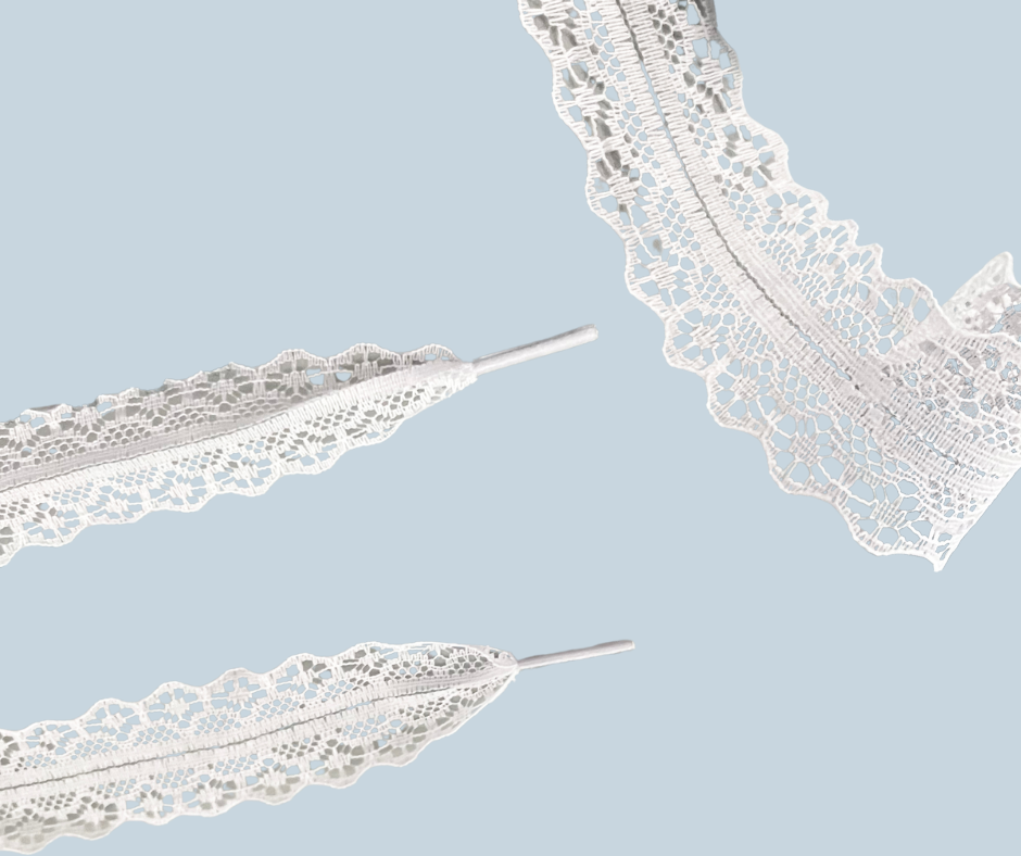 Close-up of white lace shoelaces on a light blue background