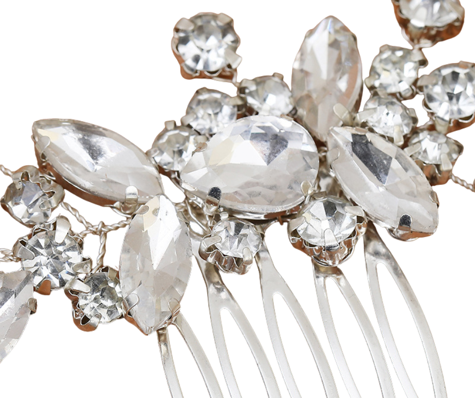 Close-up of a decorative rhinestone hair comb with crystals on a white background