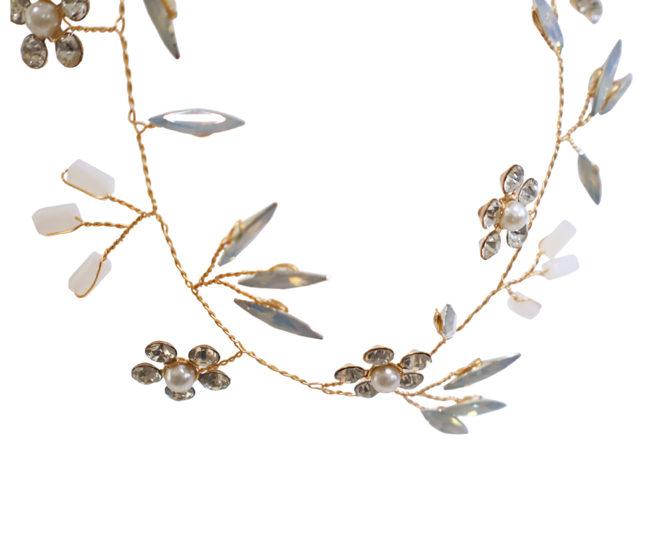 Delicate gold hair vine with floral and leaf designs on a white background