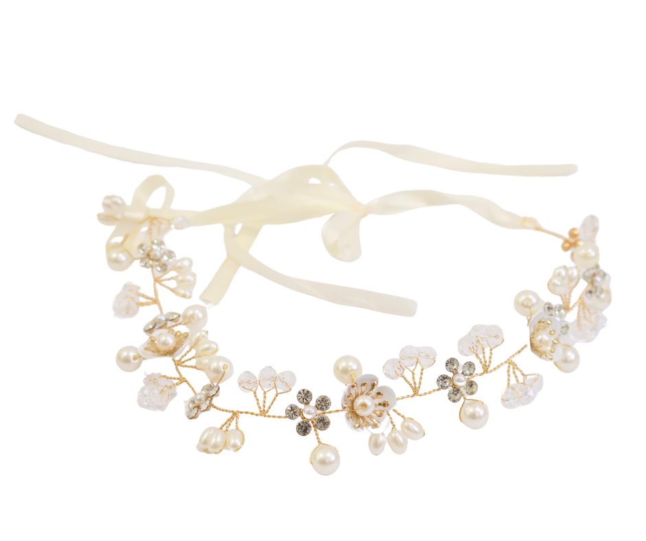 Delicate headband with pearls and flowers on a white background