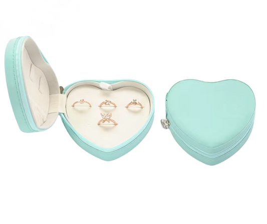 Blue Heart-shaped jewellery box with rings inside on a white background