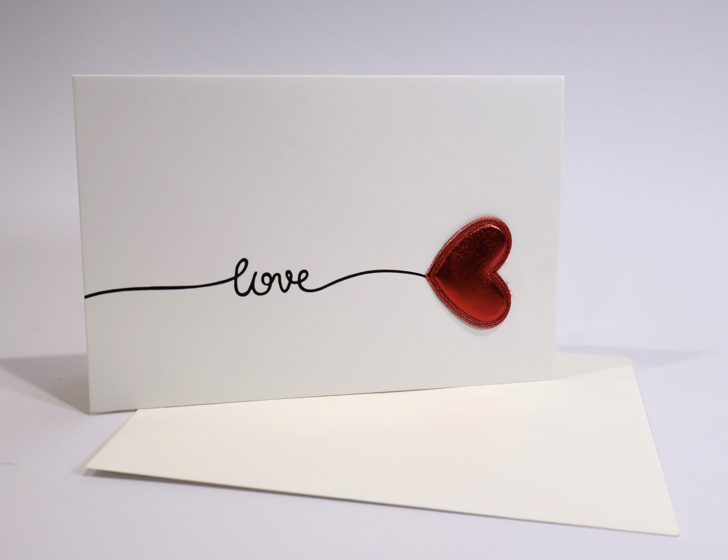 Card with red heart and 'love' text on a white background