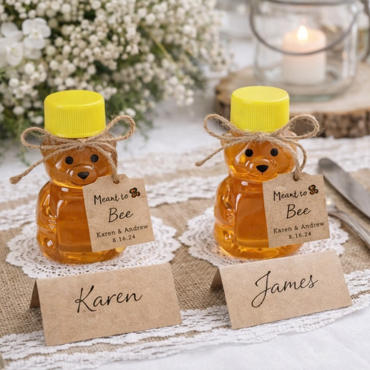 Two honey bear jars with yellow lids on a decorative tablecloth with name tags.