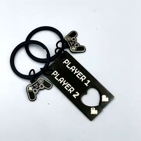 Keychain with 'Player 1' and 'Player 2' charms on a white background