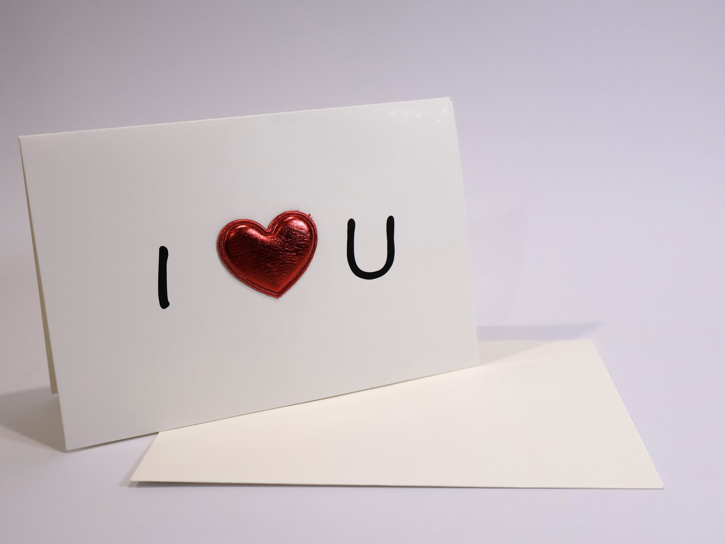 Greeting card with 'I ❤️ U' text on a white background