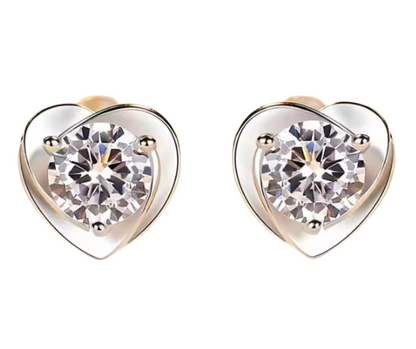 Heart-shaped moissanite stud earrings on a white background