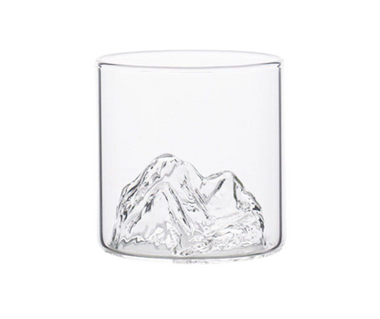 Clear glass tumbler with mountain design on a white background