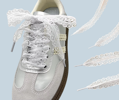 White sneaker with lace shoelaces on a light blue background