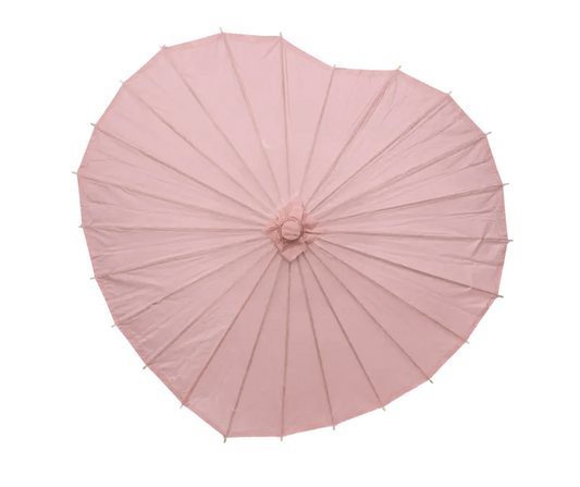 Pink heart shaped paper parasol on a white background