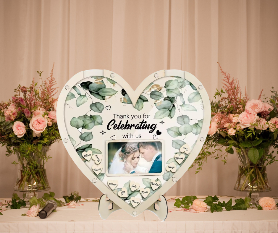 Heart-shaped guest frame with floral design on a decorative table with flowers and ribbons.