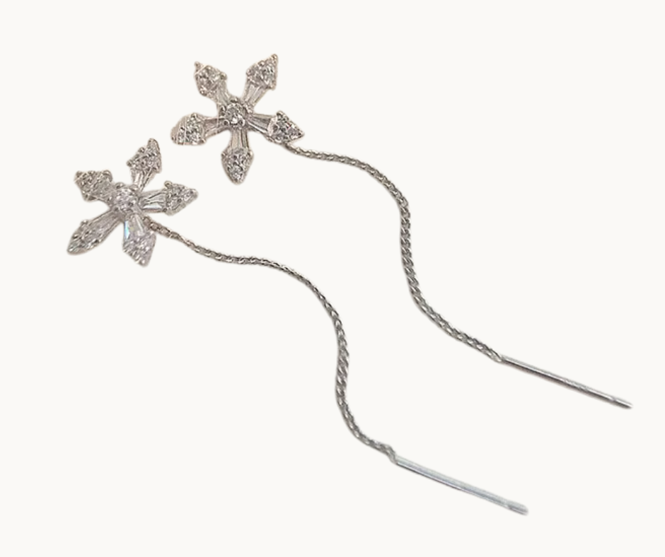 Silver floral thread earrings on a white background