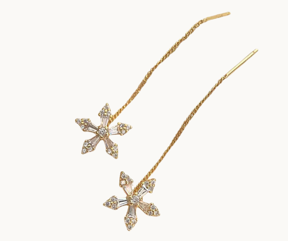 Gold flower-shaped earrings on a white background