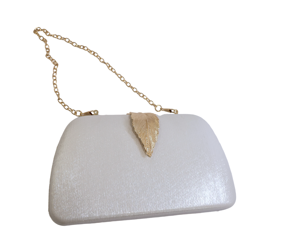 White clutch bag with gold chain strap and leaf detail on a white background