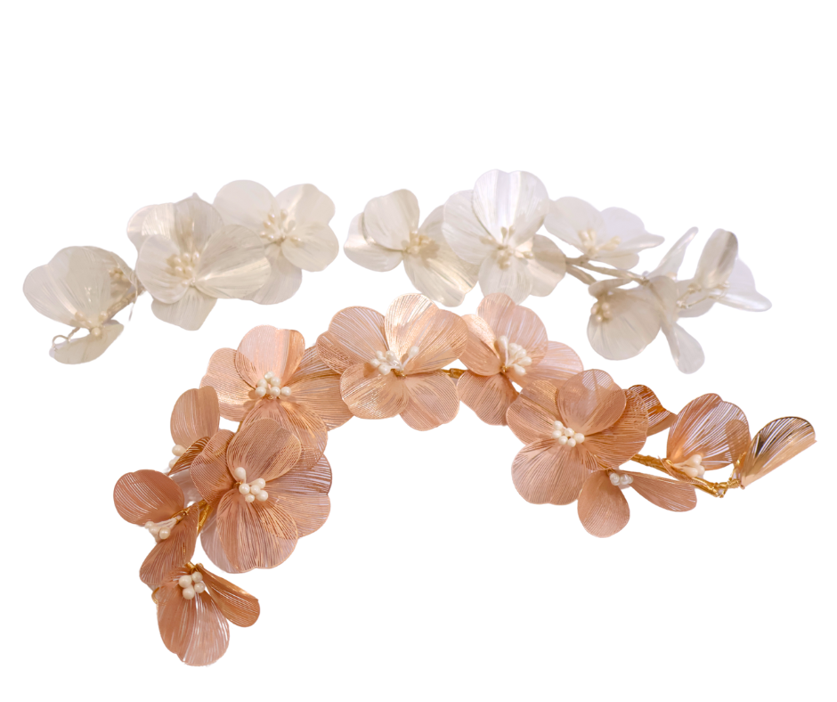 Floral hair accessory in gold and white on a white background