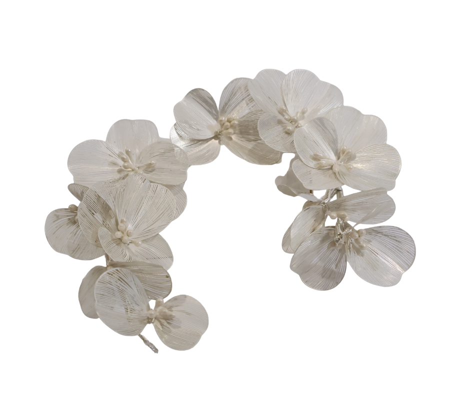 Decorative floral hair piece with white flowers on a white background