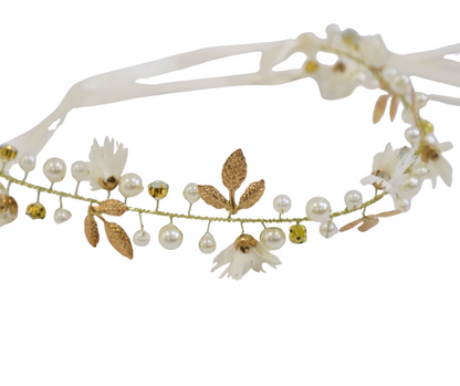 Floral hair accessory with pearls and leaves on a white background