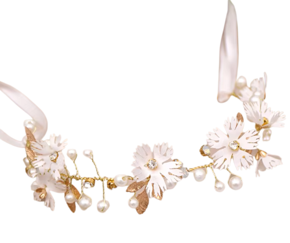 Floral hair piece with pearl accents on a white background