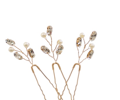 Decorative branch hairpins with small pearls and beads on a white background
