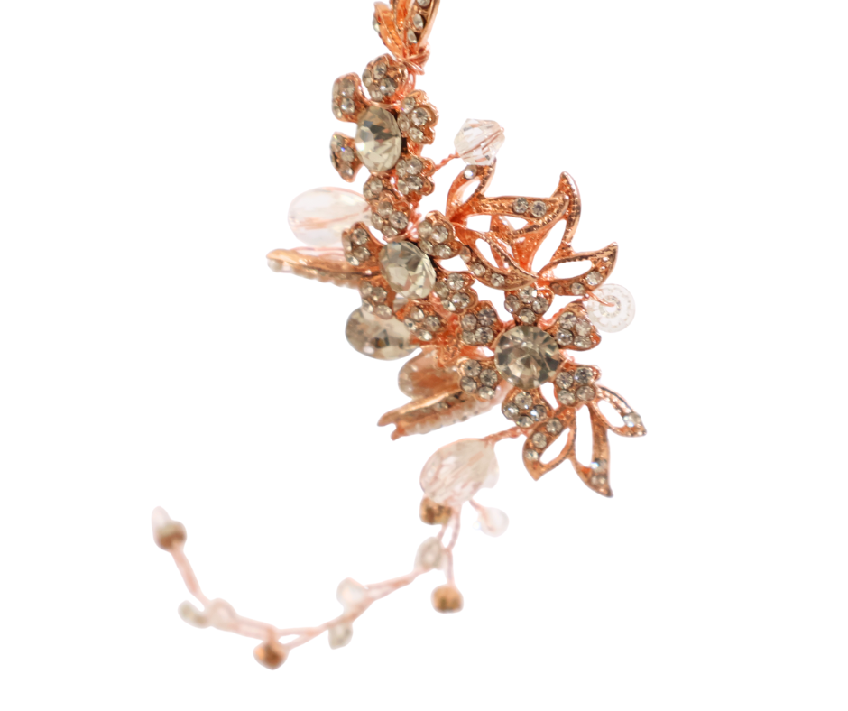 Rose gold hair piece with floral design on a white background