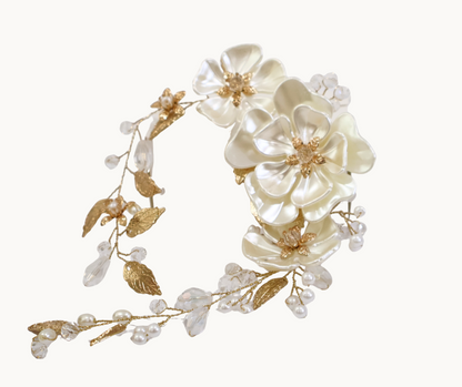 Floral headpiece with white flowers and gold leaves on a white background