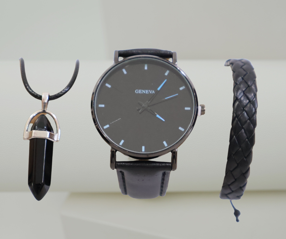 Black watch, pendant, and bracelet set on a light background