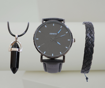 Black watch, pendant, and bracelet set on a light background