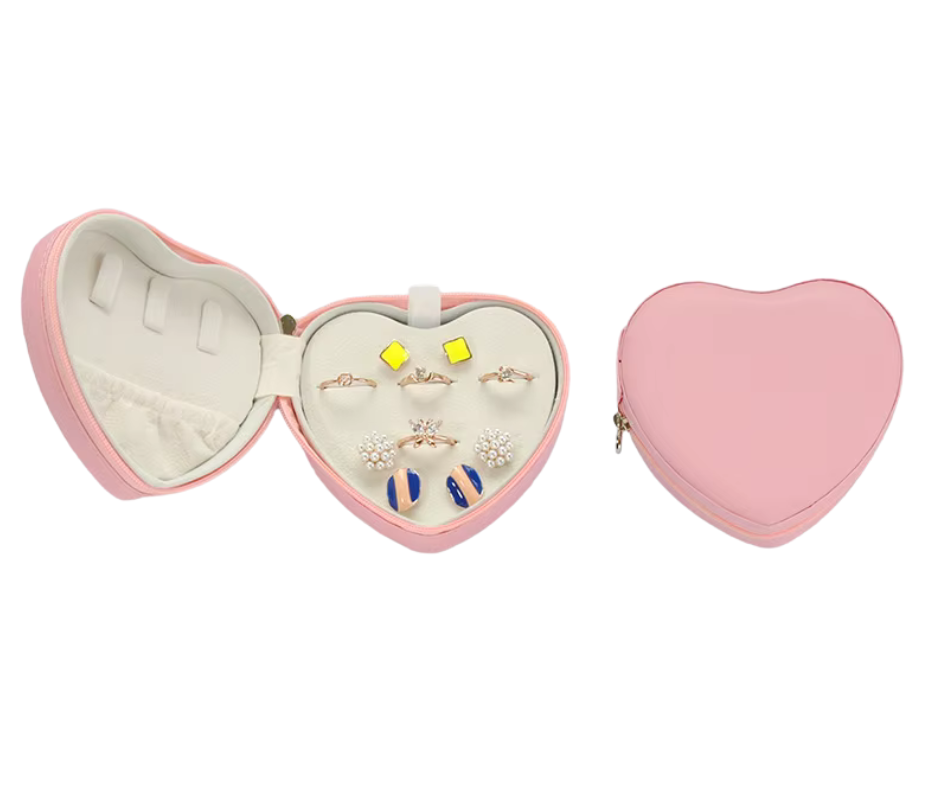 Heart-shaped jewellery case with jewellery inside on a white background
