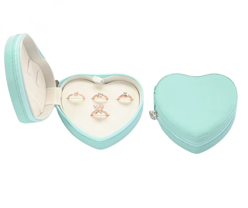 Blue Heart-shaped jewellery box with rings inside on a white background