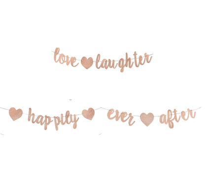 Rose gold 'love laughter happily ever after' banner on a white background