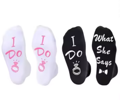 Bride+Groom sock set with two pairs of socks with 'I Do' and 'What She Says' text on a white background