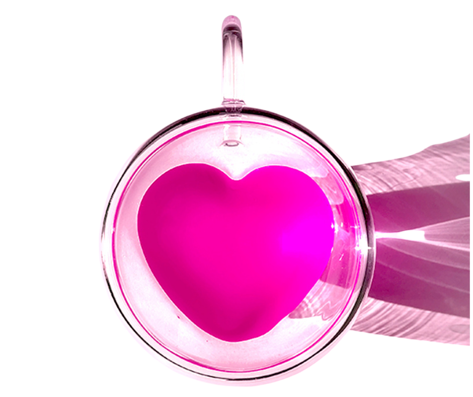 heart-shaped mug with pink liquid on a white background
