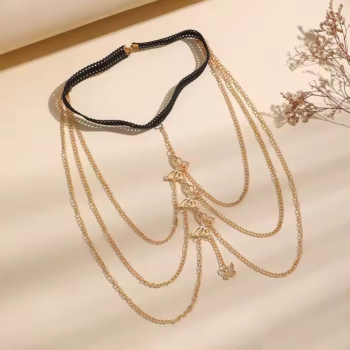 Gold chain garter with butterflies on a neutral background