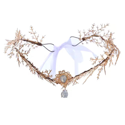 Decorative headband with gold branches and a central crystal on a white background