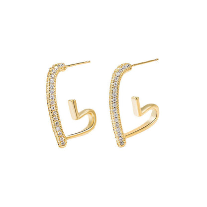 Gold hoop earrings with clear gemstones on a white background