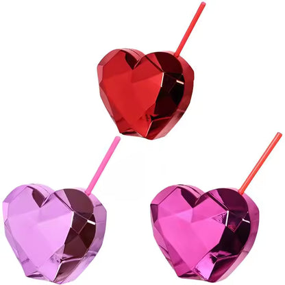 Three heart-shaped drink tumblers in red, pink, and purple on a white background