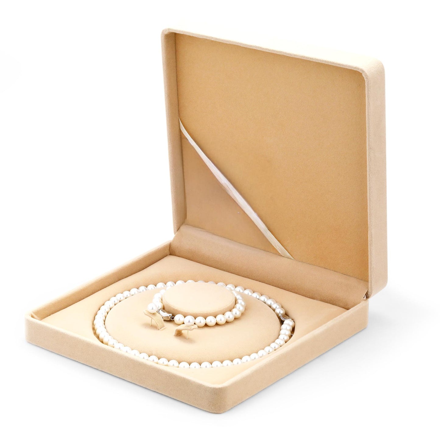 Pearl jewelry set in an open beige jewelry box on a white background
