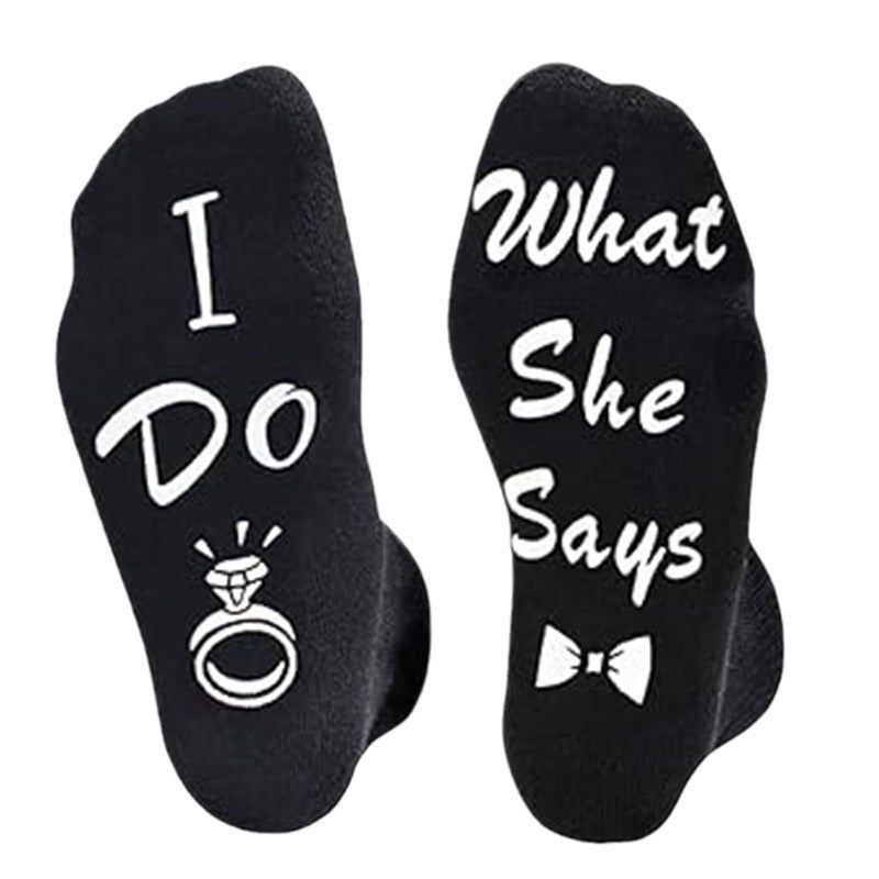 Black socks with 'I Do' and 'What She Says' text and wedding ring and bow tie symbols.