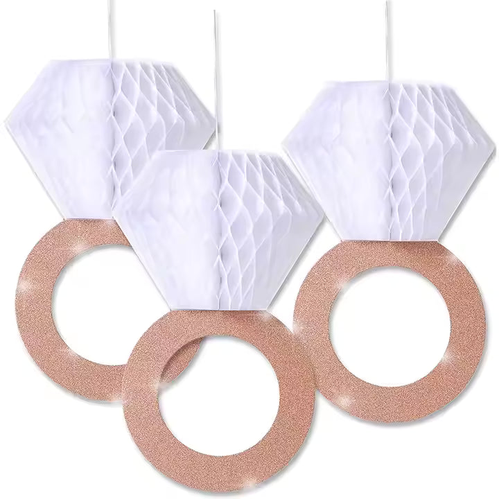 Decorative hanging rings with white honeycomb shapes and rose gold circular bases on a white background.