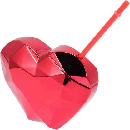 Red heart-shaped drink tumbler with a straw on a white background