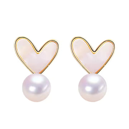 Heart-shaped earrings with pearl drops on a white background