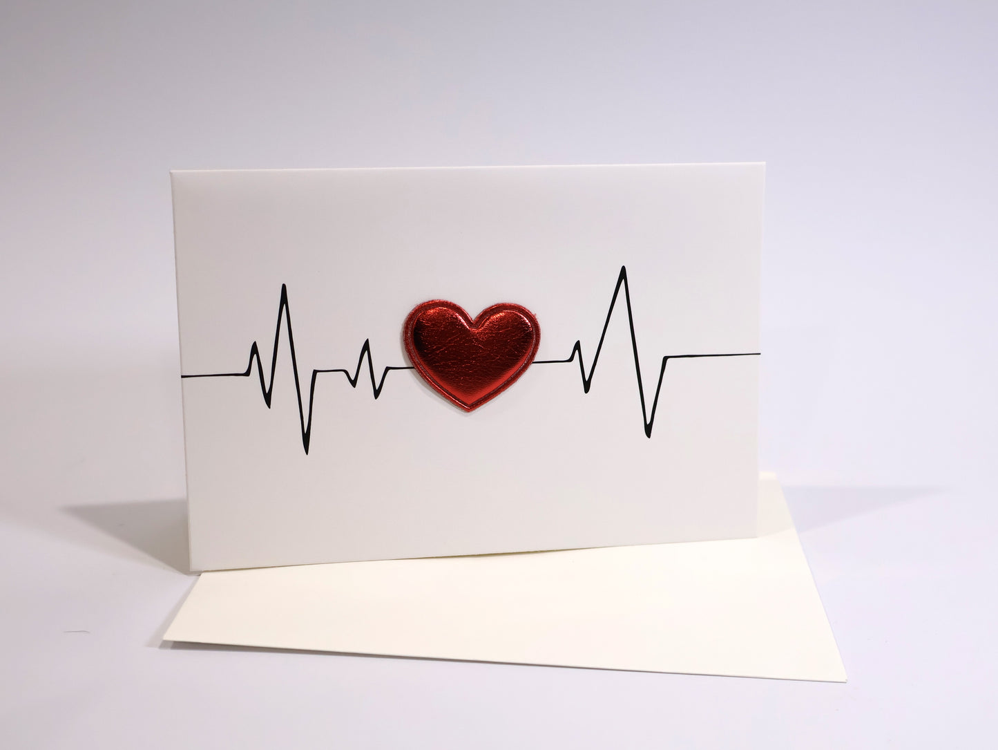 Card with a red heart and heartbeat line on a white background