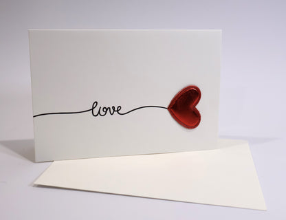 Card with red heart and 'love' text on a white background