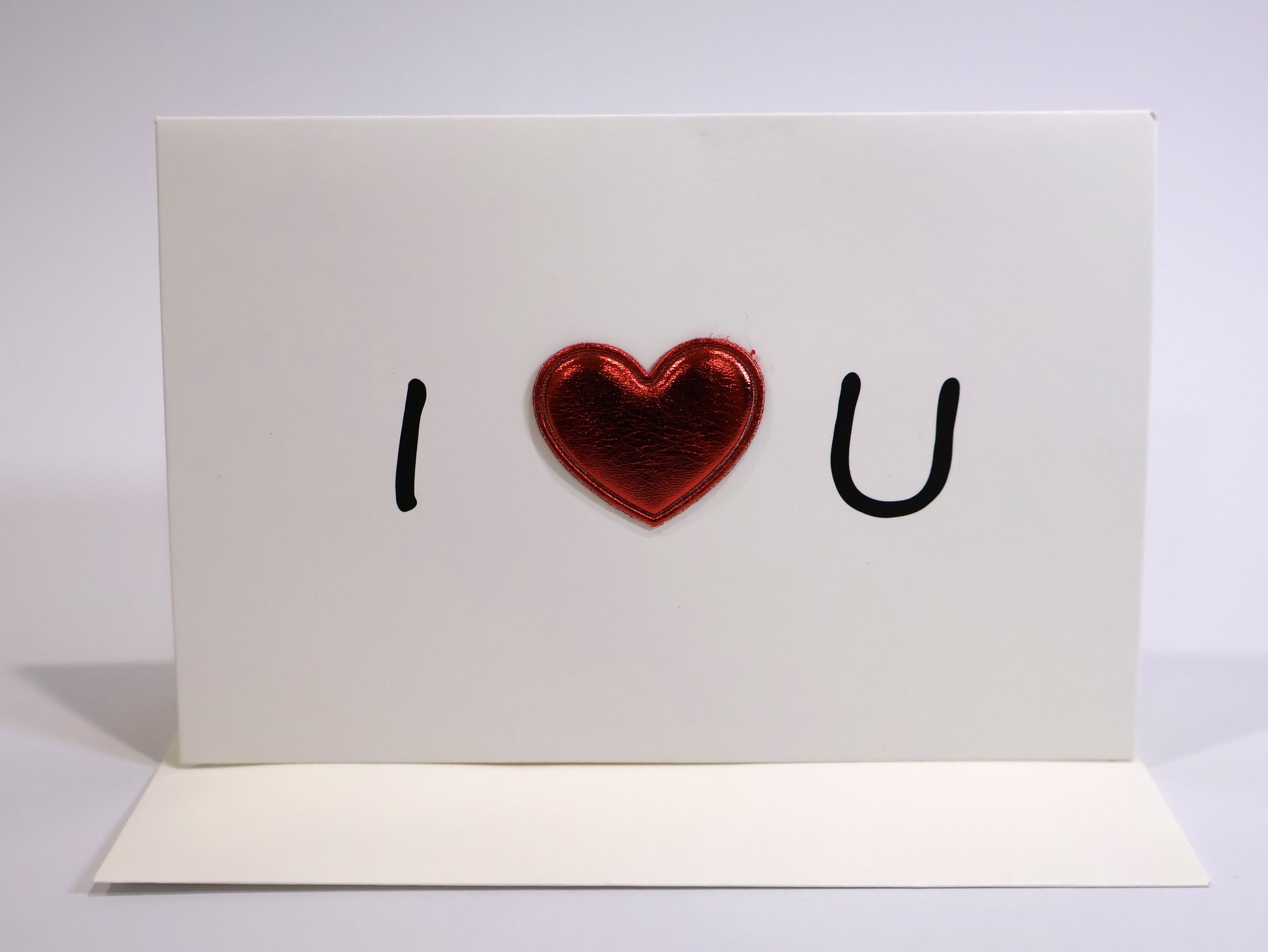 Card with 'I ❤️ U' text and a red heart on a white background