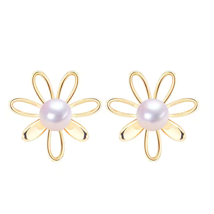 Gold flower-shaped earrings with pearl centers on a white background