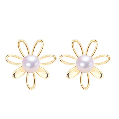 Gold flower-shaped earrings with pearl centers on a white background