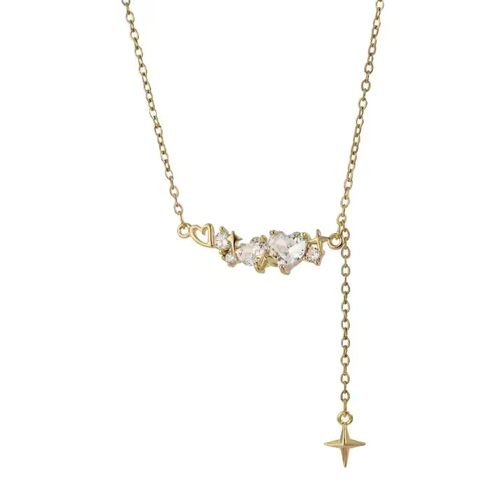 Gold necklace with heart and star pendants on a white background