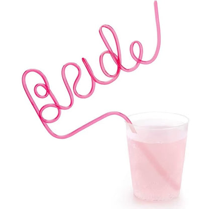 Pink 'Bride' straw with a glass of pink liquid on a white background