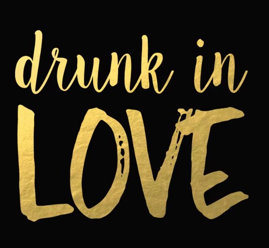 Gold temporary tattoo 'drunk in LOVE' on a black background