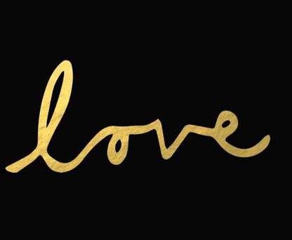 Gold 'love' temporary tattoo on a black background