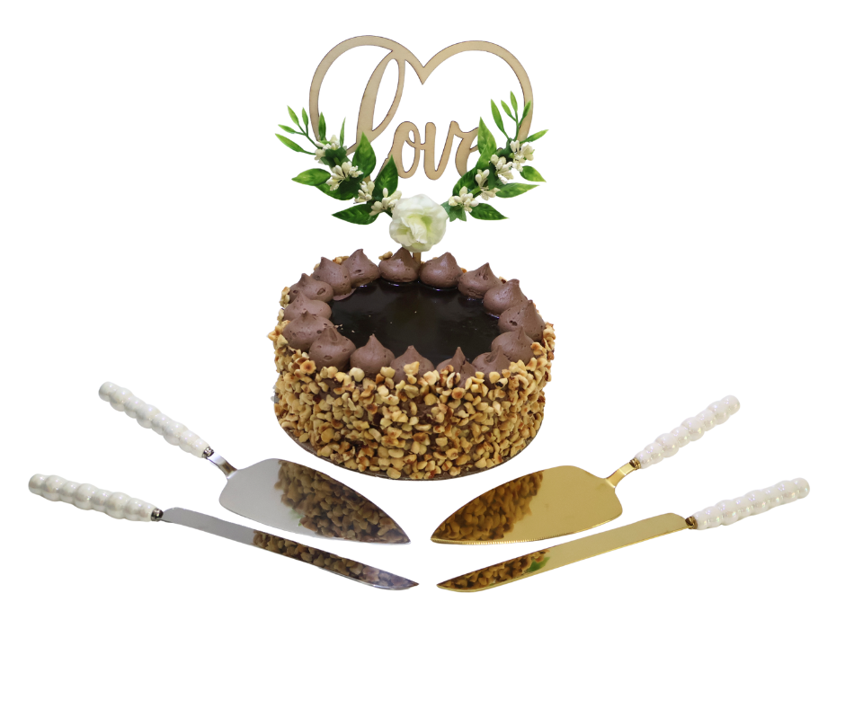 Small round cake with decorative top, 'Love' sign, and pearl cake cutting tools on a white background